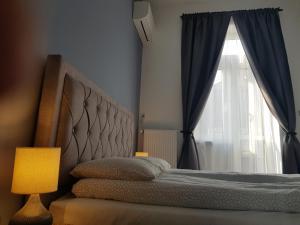 a bedroom with a bed with a large window at Luxurious Apartment with Balconies in DownTown BP in Budapest