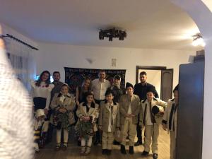 a group of people posing for a picture in a room at Pensiunea Trei Lalele in Moisei