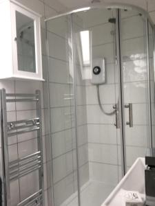 a shower with a glass door in a bathroom at Montague Villa in Dunoon +41 photos