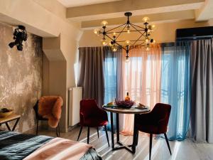 a room with a table with chairs and a chandelier at Studio lux Loft on Victory street in the City Center in Vinnytsya