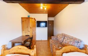 a living room with a couch and a table at Pension Schlossbergblick in Simonswald