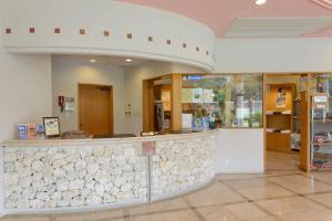 a lobby with a stone counter in a store at Marine Lodge Marea in Miyako Island