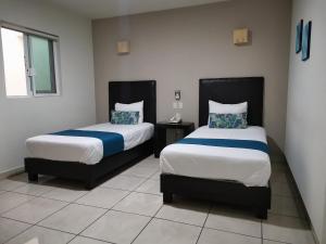 Ένα ή περισσότερα κρεβάτια σε δωμάτιο στο Hotel Pabela