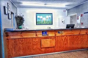 an office with a reception desk with a sign on it at Best Inn in Augusta