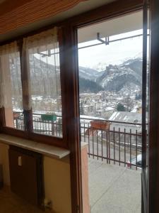 a window with a view of a mountain at Casa Ciliegia in Vernante