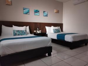 Ένα ή περισσότερα κρεβάτια σε δωμάτιο στο Hotel Pabela