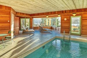 a house with a swimming pool in a room at Le Manoir Au Lac in Gérardmer