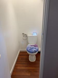a bathroom with a toilet with a blue seat at L'Imprenable vue mer in Crozon +37 photos