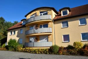 a large building with a balcony on the side of it at Strandnahe, familienfreundliche Ferienwohnung auf Usedom in Koserow in Ostseebad Koserow