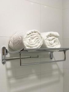 a towel on a towel rack in a bathroom at Hotel Barreto in Nossa Senhora da Glória