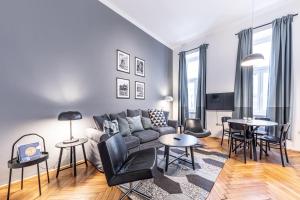 a living room with a couch and tables and chairs at Eddie’s Design Apartments in Vienna