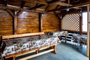 two benches in a room with wooden walls at Casa de Oaspeti la Bilbor in Bilbor
