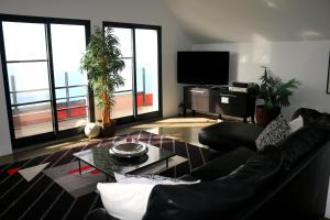 a living room with a couch and a table at Madeira Native Motion Apartment in Ponta do Pargo