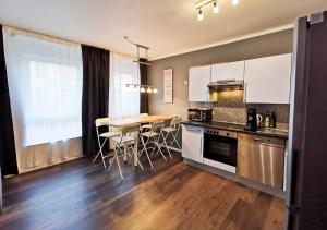 a kitchen with a table and chairs in a room at spacious studio - city centre - airconditioned - netflix - terrace in Heidelberg