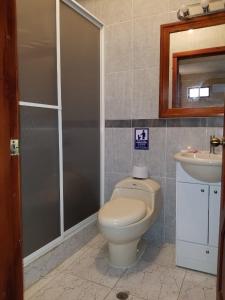 a bathroom with a toilet and a sink at Hotel Soberao in Esmeraldas