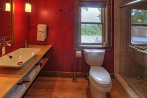 a bathroom with a toilet and a sink and a window at Stone Hill Overlook in Hermann