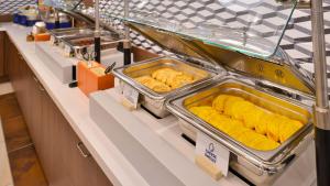 a buffet line with trays of food on a counter at Ramada by Wyndham Prince Albert in Prince Albert