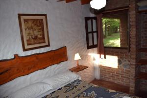 a bedroom with a bed and a window at Cabañas La Rosada in Santa Rosa de Calamuchita +83 photos
