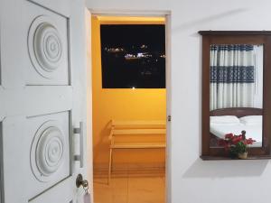 a room with a bed and a window and a door at Mount View Inn in Kandy