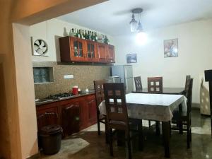 a kitchen with a table and chairs and a kitchen with a stove at Mount View Inn in Kandy