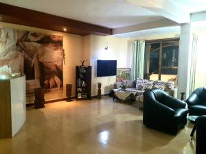 a living room with a couch and a tv at Mount View Inn in Kandy