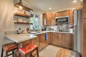a kitchen with wooden cabinets and a stainless steel refrigerator at Sedona Casita on Thunder Mountain Walk to Trails in Sedona