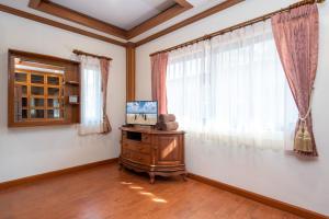 a living room with a television and a window at Private Villas Bangtao in Bang Tao Beach