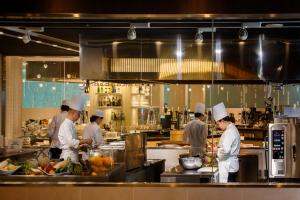 a group of chefs preparing food in a kitchen at Midorinokaze Resort Kitayuzawa in Date