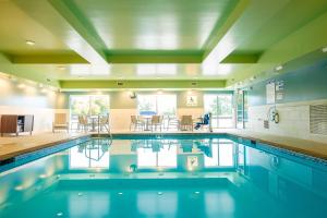 a swimming pool in a building with a dining area at Holiday Inn Express & Suites Eagan - Minneapolis Area, an IHG Hotel in Eagan