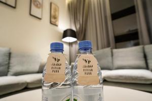 two bottles of water sitting on top of a table at Vivian Park Al Rawabi in Riyadh