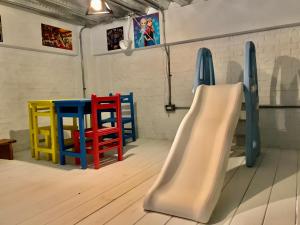 a room with colorful chairs and a slide at Huatian Yilu in Xiulin