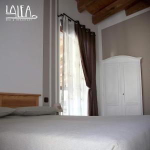 A bed or beds in a room at Affittacamere La Lea