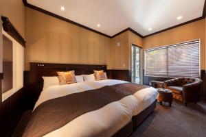 Un pat sau paturi într-o cameră la Karuizawa Hotel Longing House