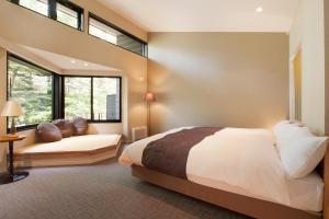 Postel nebo postele na pokoji v ubytování Karuizawa Hotel Longing House