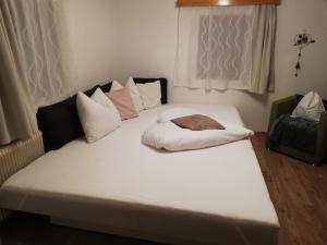duże białe łóżko w pokoju w obiekcie Gaestehaus-Russegger w mieście Abtenau