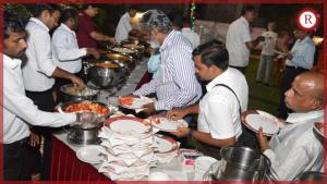 a group of people standing around a table with food at Hotel RAKS in Thanjāvūr