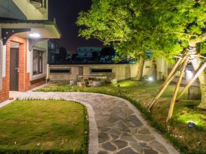 a garden with a stone walkway in front of a house at Qing Ping Jn Humanities Hall青萍居人文會館 in Wujie