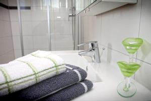a bathroom with a sink with a towel and a glass at Haus Steinfeld in Kirchberg an der Raab