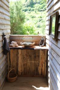 a bathroom with a sink on a wooden wall at Kereru site in Waihi
