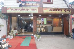 a building with a red and blue carpet in front of a store at HOTEL RUDRAKSHA INN in Deoghar