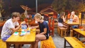 a group of people sitting at tables in a restaurant at I am Backpacker Hostel in Sabang