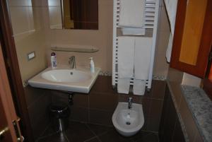 a bathroom with a sink and a toilet at Agriturismo Torre Cristina in Aprilia