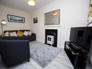 a living room with a couch and a fireplace at Belmullet Townhouse in Belmullet