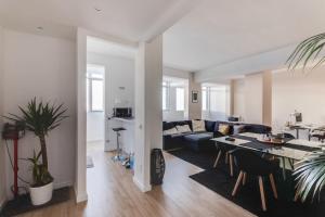 a living room with a couch and a table at Camera Deluxe in favoloso attico vista mare in Rimini