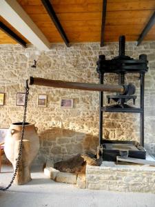 a room with a stone wall with aslave at Cleopatra deluxe with jacuzzi apart in Kamilari with panoramic view in Kamilari