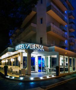 a building with a sign that reads julius vienna at night at Hotel Vienna in Gabicce Mare