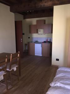 a room with a kitchen and a table and chairs at Ababo Affittacamere in Quattro Castella