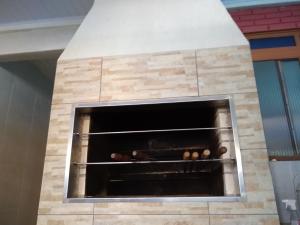 a stone fireplace with some food inside of it at Casa do scur in Canela