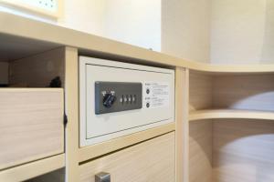 a microwave oven sitting inside of a kitchen at Meitetsu Inn Hamamatsucho in Tokyo +35 photos