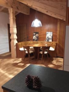 a dining room with a table and chairs and a pine cone at Chalet-style Apartment with Matterhorn View in Zermatt